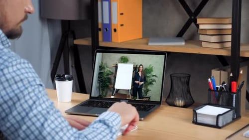 Man Attends Online Presentation and Takes Notes