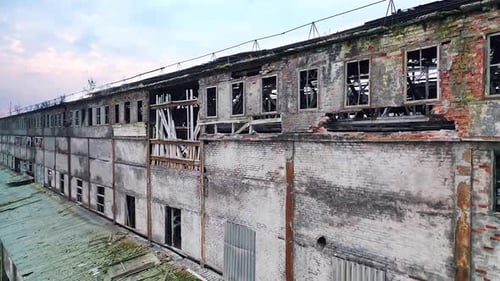 Aerial view from the air to an abandoned factory. Old industrial building for demolition.