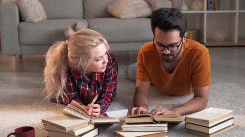 Couple Studying Together with Books in Living Room