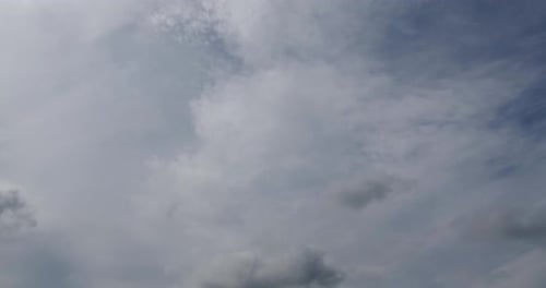 Dramatic White Clouds Moving Across a Blue Sky