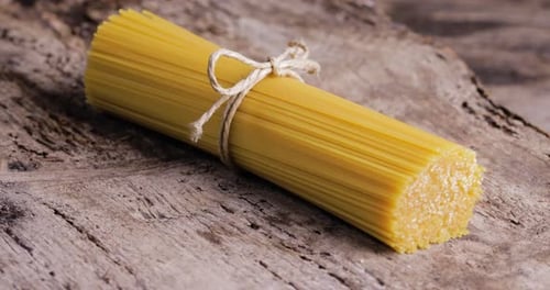 Raw Spaghetti Bundle Tied on Rustic Wood