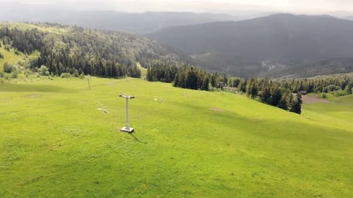 Aerial View Flight Over a Ski Lift in the Mountains in Summer. Tourist Mountain Lift From a Height.