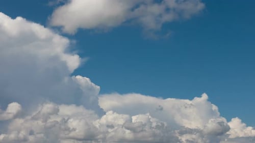 White Clouds Moving Across a Blue Sky Time Lapse