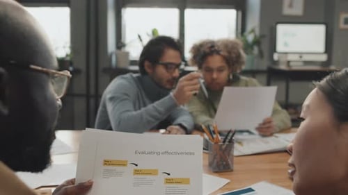 Team Collaborates on Business Strategy in Bright Office