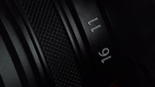 Macro View of Rotation Mirrorless or DSLR Camera Aperture Ring. Changing the Focus Setting on Old