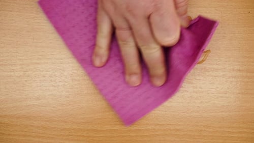 Hand Wipes Water with Cloth on Wood Surface