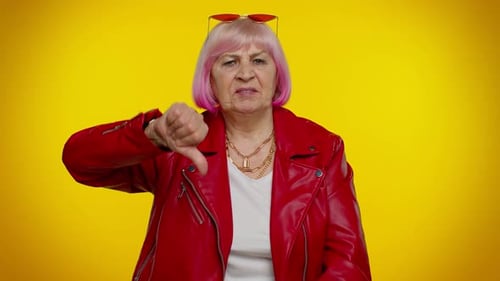 Mature Woman Disapproves, Gives Double Thumbs Down
