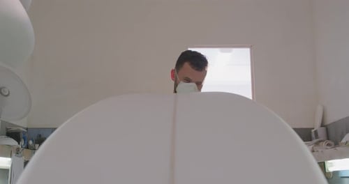 Male surfboard maker in his workshop