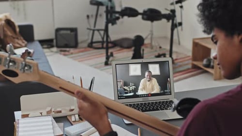 Student Receives Online Guitar Lesson from Instructor
