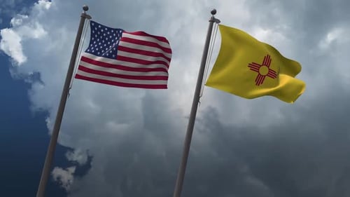 Waving American and New Mexico State Flags on Flagpoles