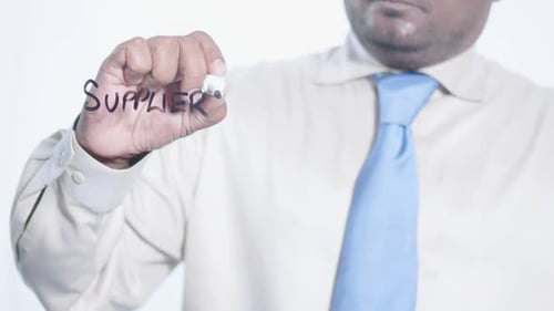 Asian Businessman Writes Suppliers