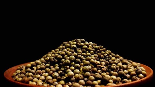 Pile of Whole Coriander Seeds on Dark Background