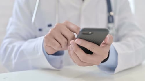 Close Up of Doctor Using Smartphone