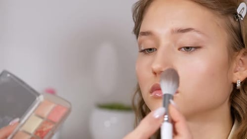 Woman Getting Makeup Applied with Brush Close Up