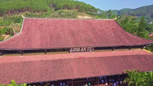 Flycam Opens View of Pagoda Backyard Against Plants Hills