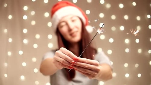 Festive Young Adult Holding Sparkler Indoors