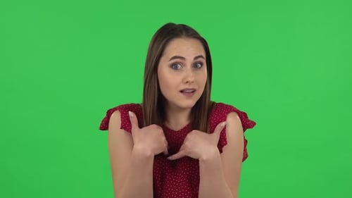 Portrait of Tender Girl in Red Dress Is Pointing Herself, Say Who Me No Thanks i Do Not Need. Green