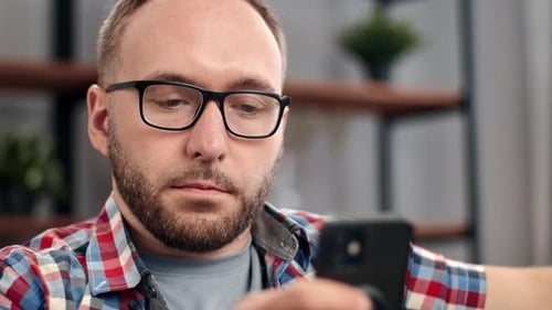 Man with Glasses Using Mobile Phone