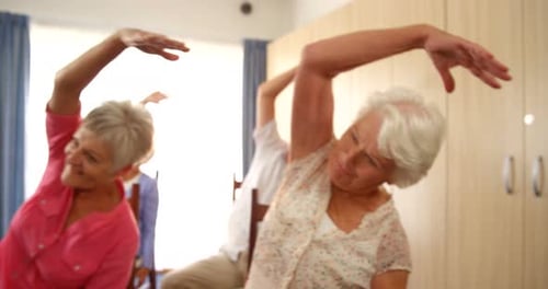 Active Seniors Exercising Together in Seated Class