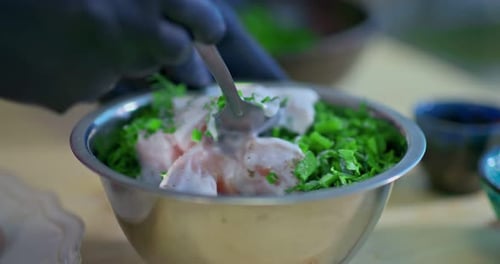 Preparing Raw Chicken With Fresh Herbs in Kitchen