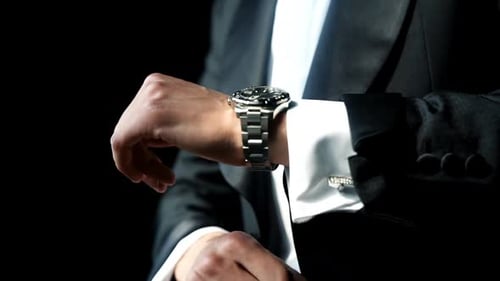 Close Up View of Man Adjusts His Suit