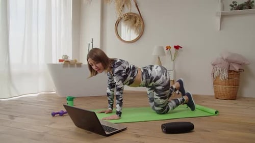 Woman Working Out Doing Donkey Kick Exercises