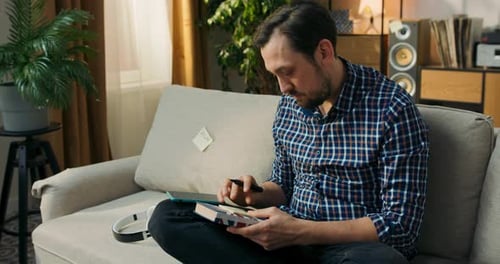 A Young Men is Studying for an English Exam