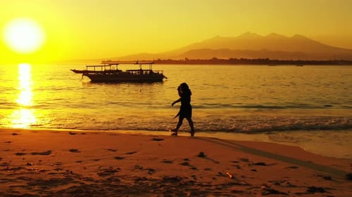 Pretty smiling girl relaxing in the sun on the beach on summer white sandy and blue 4K background