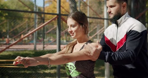 Woman Working Out with Resistance Band in Urban Park