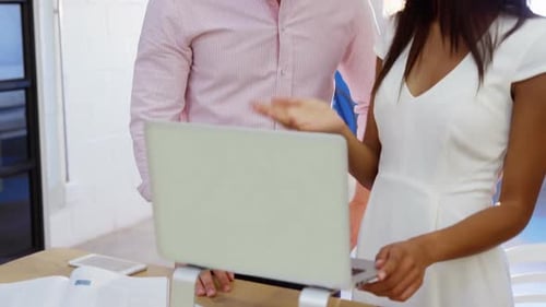 Young Adults Discussing Work in a Bright Office