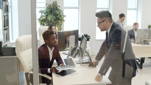 CEO and Manager Discussing Work in Office