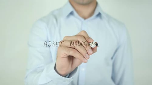 Man Writes Asset Management On Clear Surface