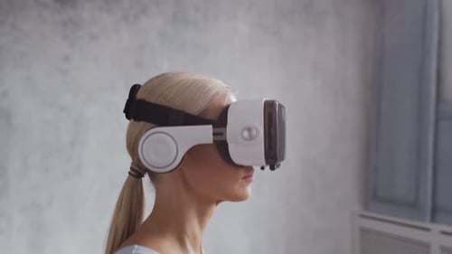 Woman Using VR Headset on Treadmill Indoors