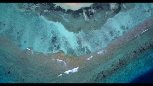 Aerial scenery of idyllic seashore beach break by transparent lagoon with white sandy background of