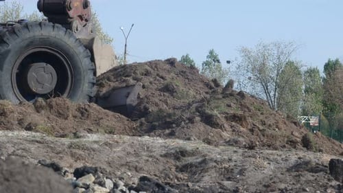 Excavator Moving Soil on Construction Site