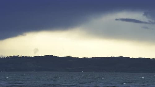 Breathtaking View of the Vast Ocean and Dark Clouds Clearing Up