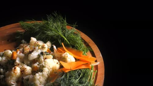Plate with Cauliflower and Carrots on Dark Background