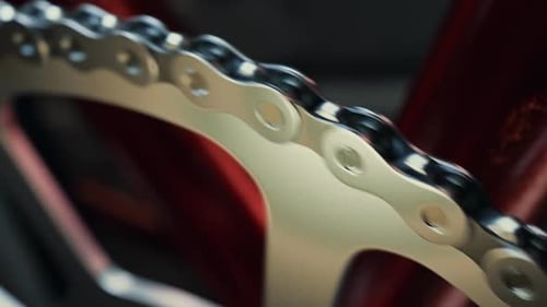 Bicycle over a black background. Loopable shot of spinning chain and chainring.