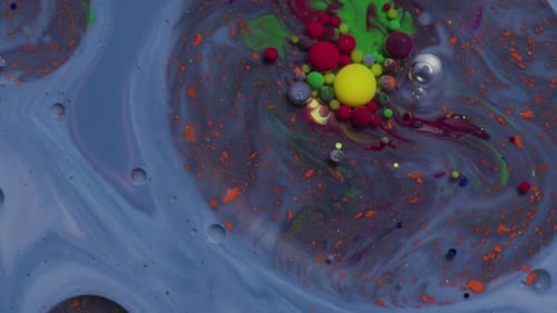 Abstract close up texture of oil with orange, blue, yellow and red paint