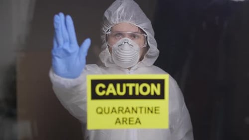 Woman in Protective Suit in Quarantine Zone Signed Stop. Coronovirus and Isolation Concept