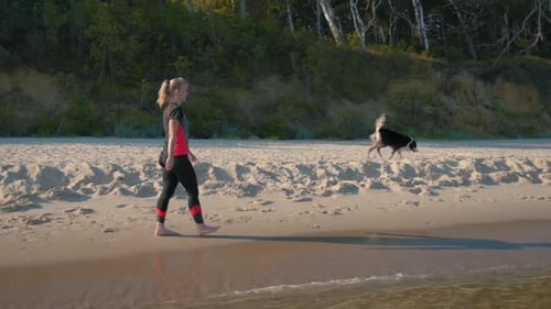 Woman with Dog on Beach