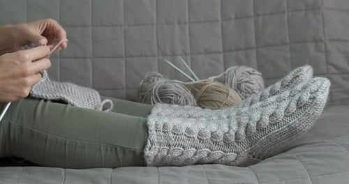 Woman Knitting at Home on Couch