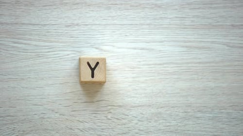 Wooden Blocks Spell 'Yes' on Table