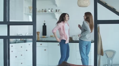 Two Friends Dancing in a Bright Kitchen
