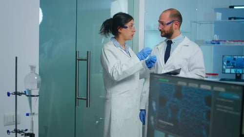 Scientists Discussing Research in Modern Laboratory