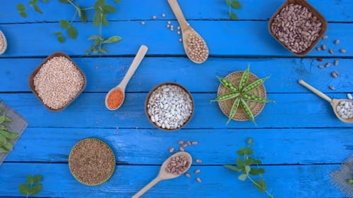 Assortment of Uncooked Legumes, Grains, and Beans on Blue Wood