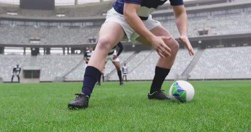 Male player passing rugby ball in the ground at stadium