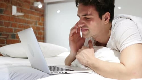 Headache, Tired Man Working on Laptop in Bed