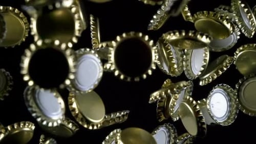 Abstract Shot of Metallic Bottle Caps Falling