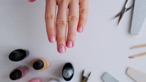 Pale Pink Nails with Dot Art Above Manicure Tools